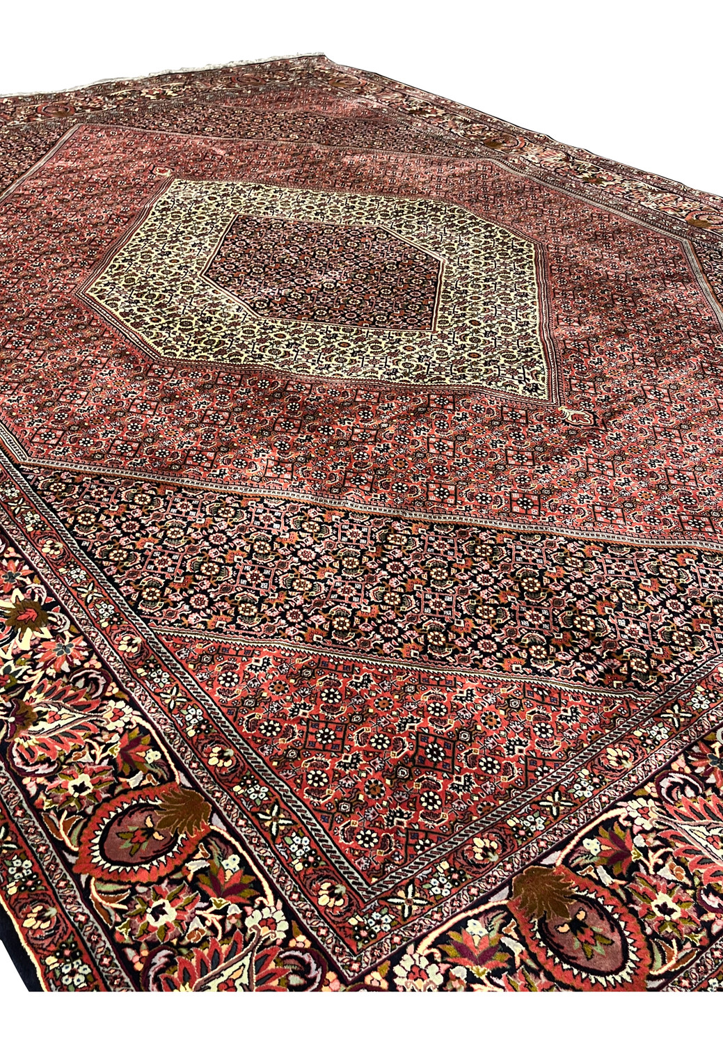 Perspective view highlighting the scale, symmetry, and deep red tones of a hand knotted Persian Bijar iron rug