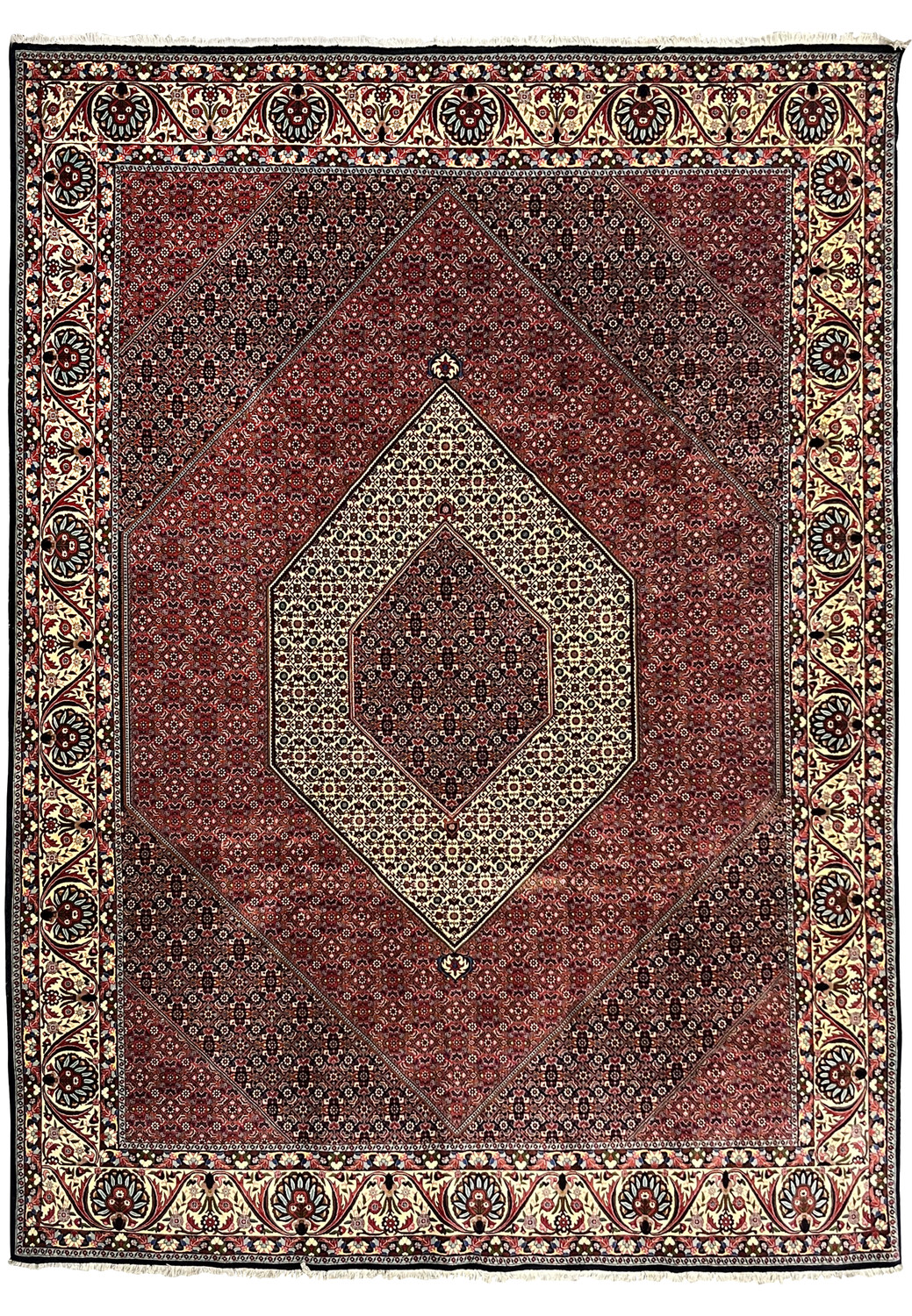 Full view of a large Persian Bijar iron rug with diamond medallion, dense red field, and wide ivory floral border