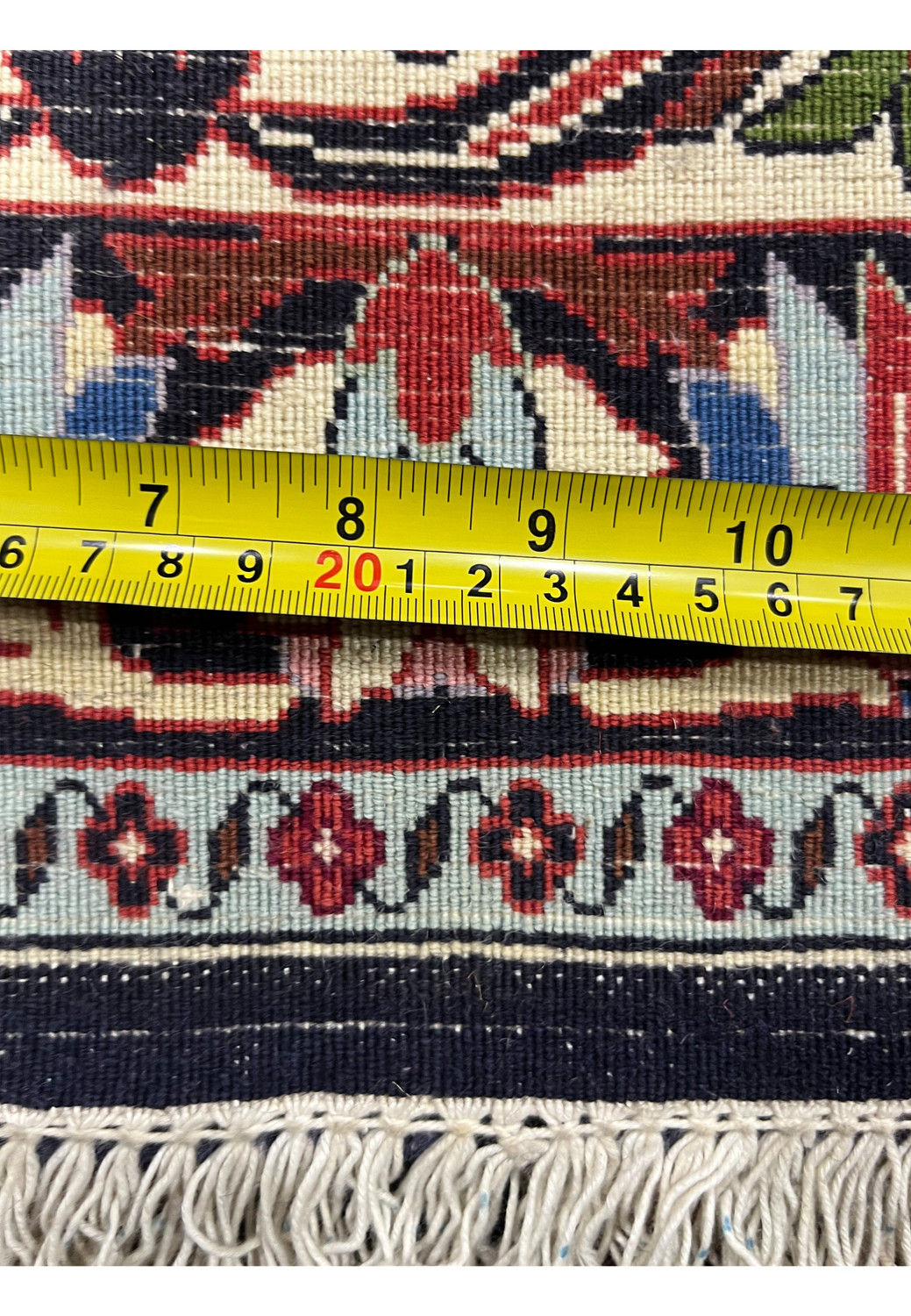 Backside view with ruler showing fine knot density and precise hand weaving of a Persian Bijar rug