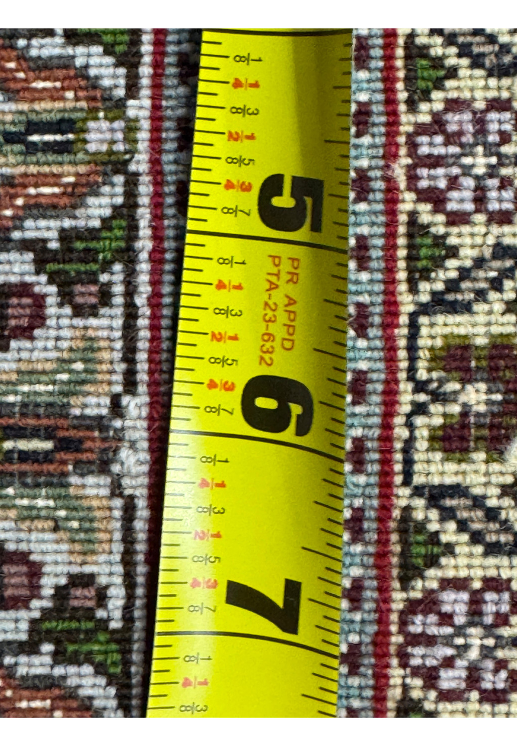 Backside view of an 11.5 x 16.5 Persian Tabriz Mahi 50 Raj rug with ruler showing dense knot count, crisp pattern clarity, fine weave consistency, and workshop level craftsmanship