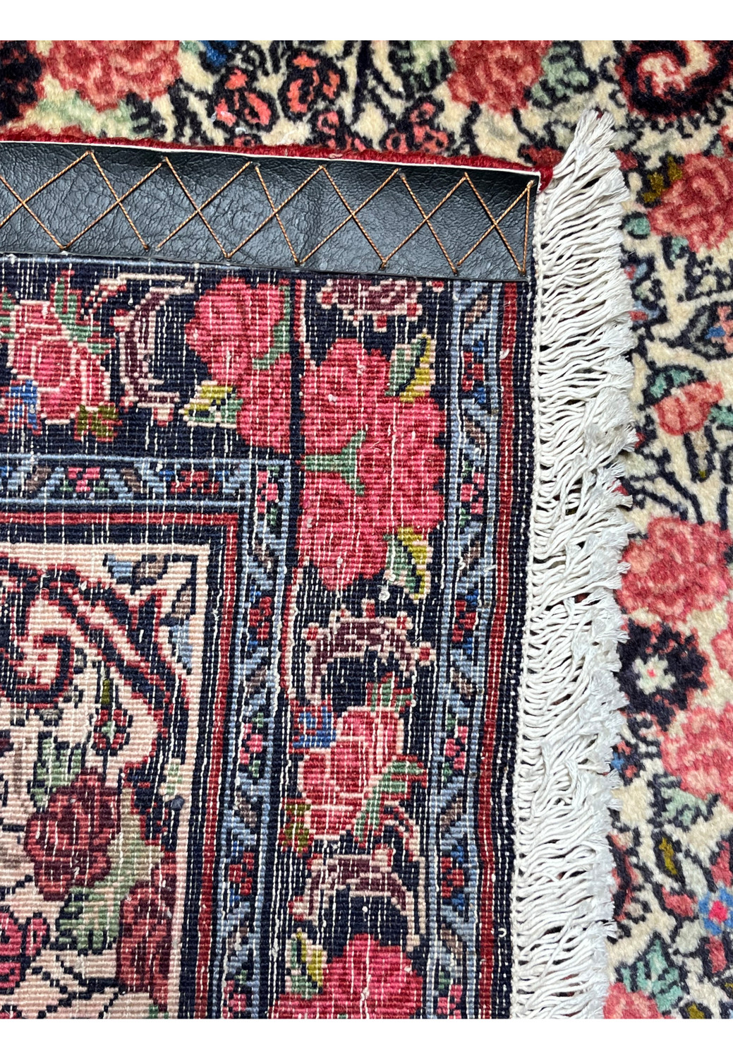 Backside detail of a 3'4 x 4'8 Persian Bijar rug showing dense hand-knotted wool foundation, floral border pattern, tight weave structure, and intact ivory cotton fringe edges