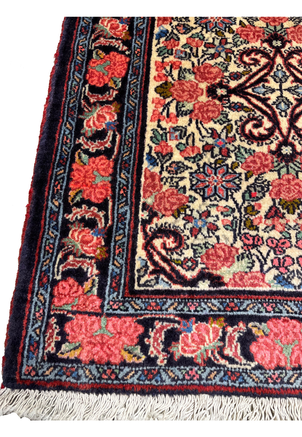 Detailed border view of a 3'4 x 4'8 Persian Bijar rug with rose flower garlands, navy ground, intricate vine work, and traditional hand knotted structure
