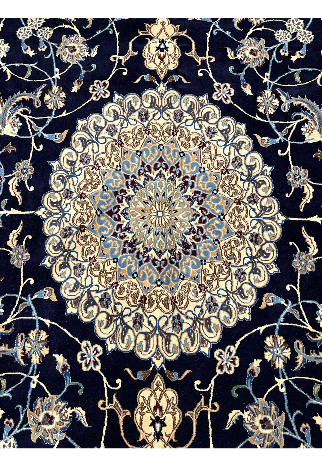Close-up of ivory floral medallion on Persian Nain silk rug showing layered rosettes, silk highlights, fine knotting, and precise symmetrical detailing.