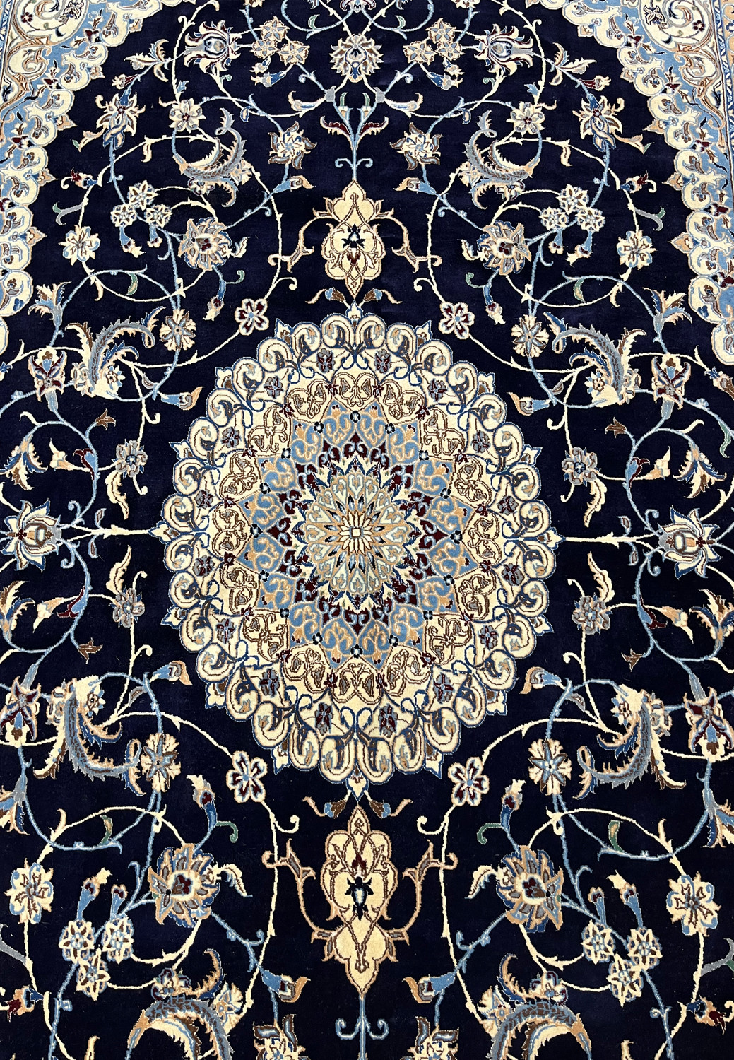 Midfield floral close-up of Persian Nain 6 LA silk rug revealing silk highlights, fine outlines, and intricate botanical motifs on navy field