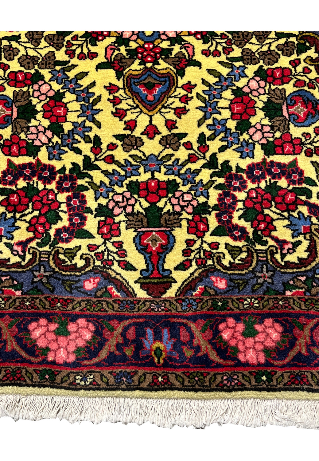 Lower border detail of Persian Bijar rug featuring deep red floral motifs, navy outlines, and traditional Kurdish design elements