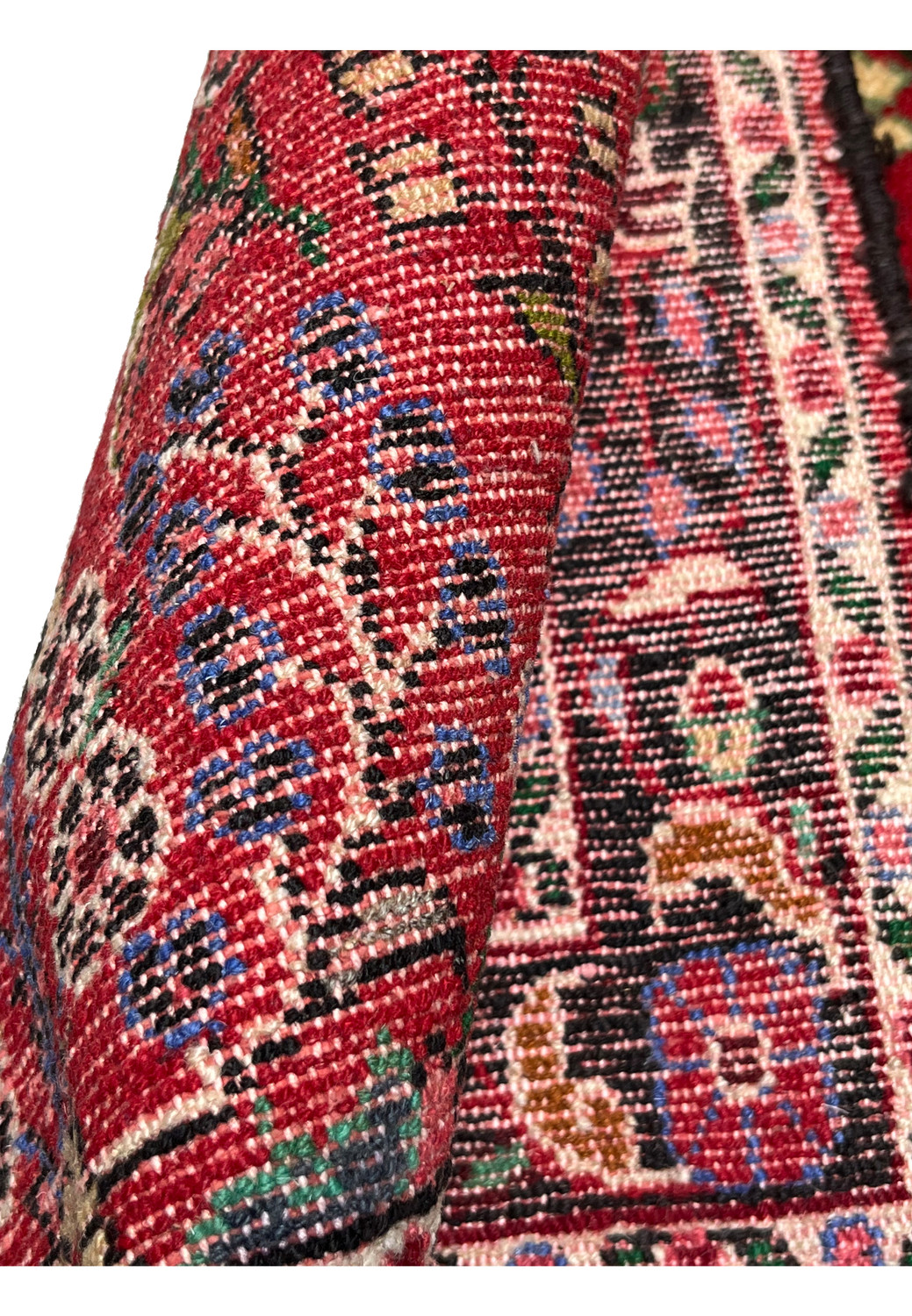 Rolled backside detail of a Persian Darjazin rug highlighting compact knot density, durable wool foundation, clean edges, and traditional tribal craftsmanship