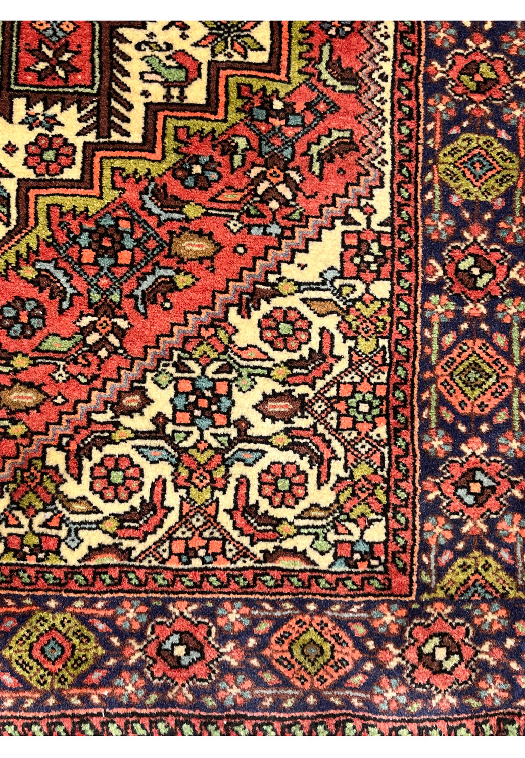 Inner border detail of Persian Gholtogh rug featuring stepped geometric patterns and crisp ivory contrast