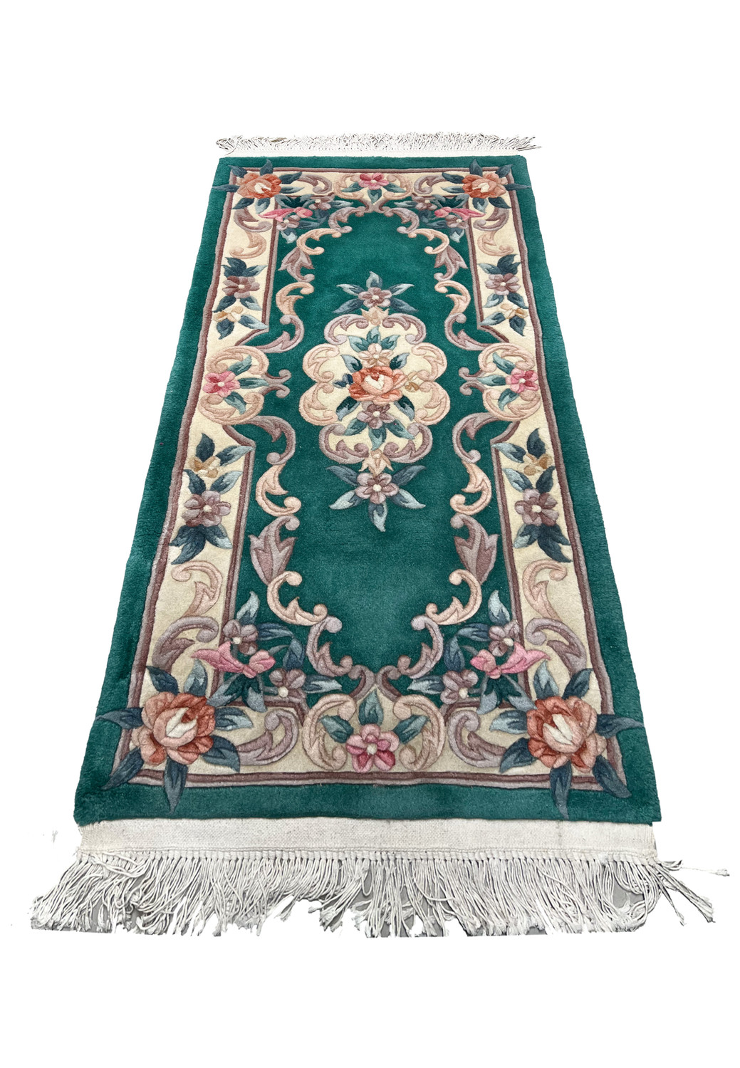 Laid flat Aubusson Art Deco rug showing emerald green background, sculpted floral scrolls, ivory framing, and balanced decorative layout