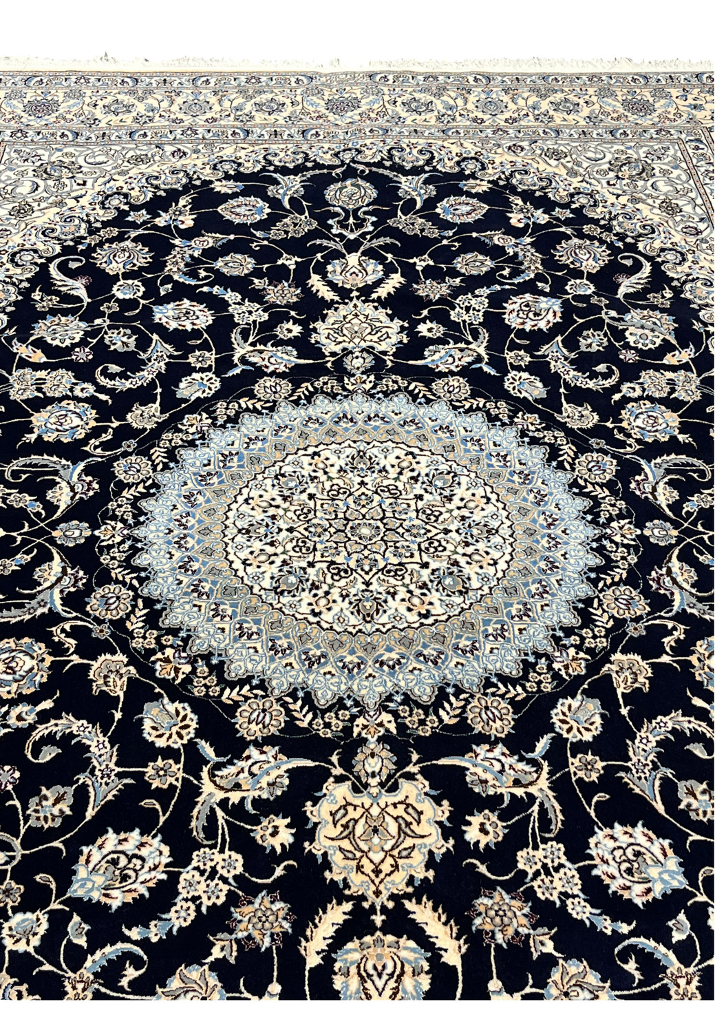 Close view of navy field on Persian Nain 6 LA Habibian silk rug highlighting intricate floral vines, silk highlights, and precise knot definition