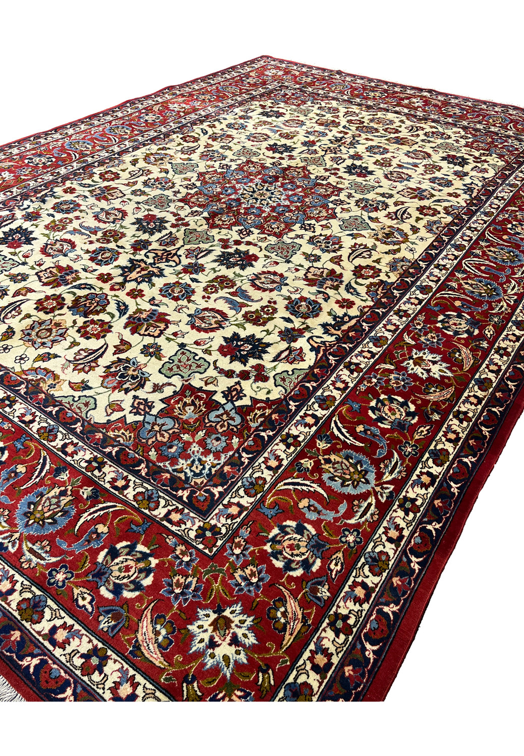 Angled perspective of an Isfahan rug emphasizing pile texture, depth of color, silk highlights, and the softness of finely spun kork wool