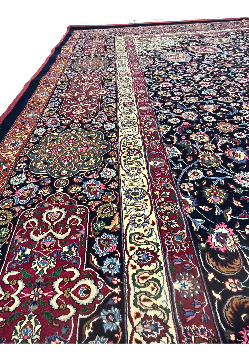 Side border view of Persian Mashad rug featuring complex floral motifs, crisp outlines, silk accents, and elegant color transitions along the edge.