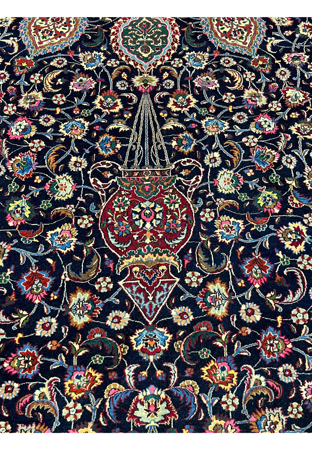 Pattern closeup of Persian Mashad rug showing fine kork wool texture, intricate floral detailing, silk accents, and high level master weaving clarity.