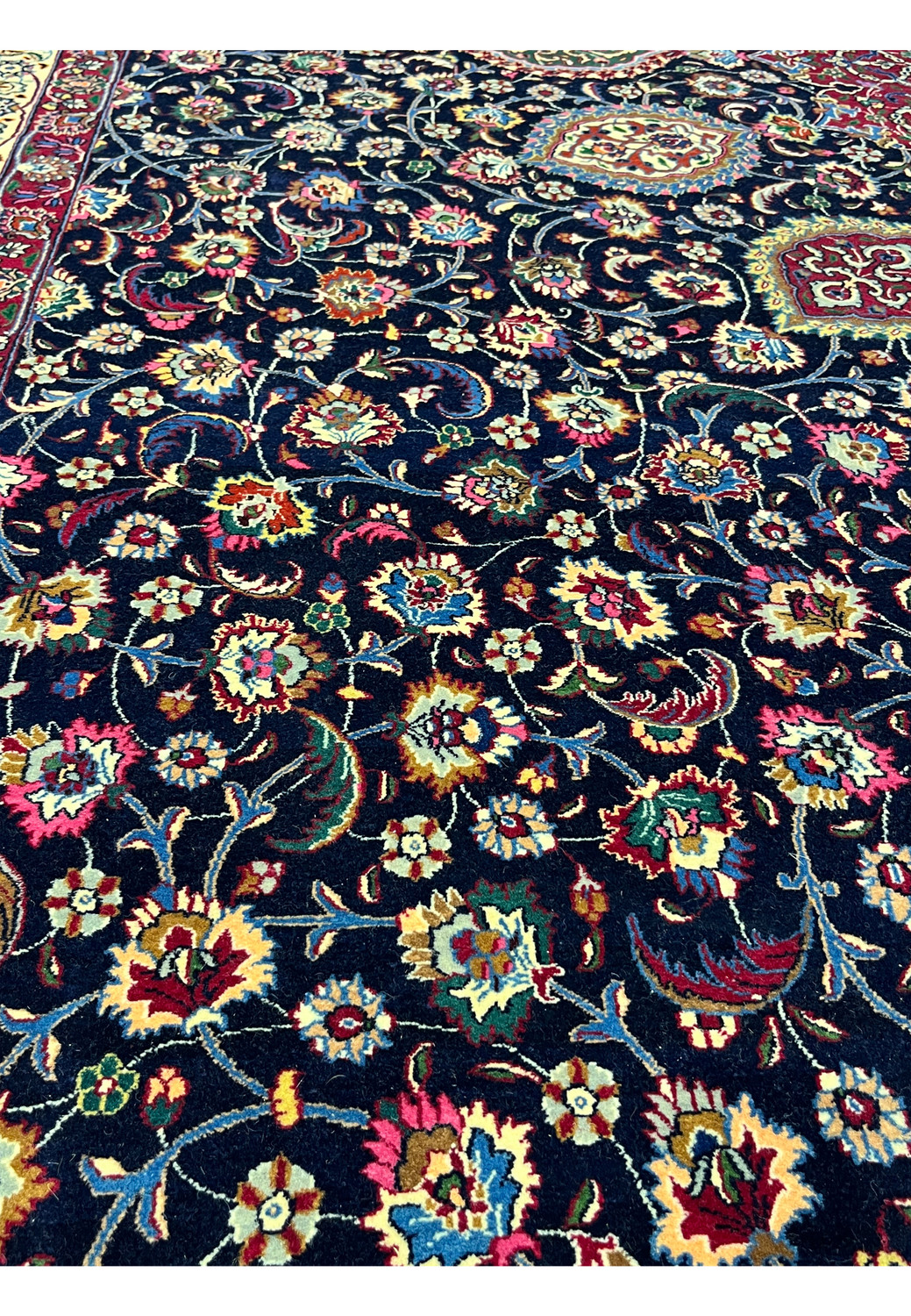 Persian Mashad rug floral pattern with dense vine scrolls, navy field, vibrant reds and greens, hand-knotted in kork wool and silk, signed Sheshkalani