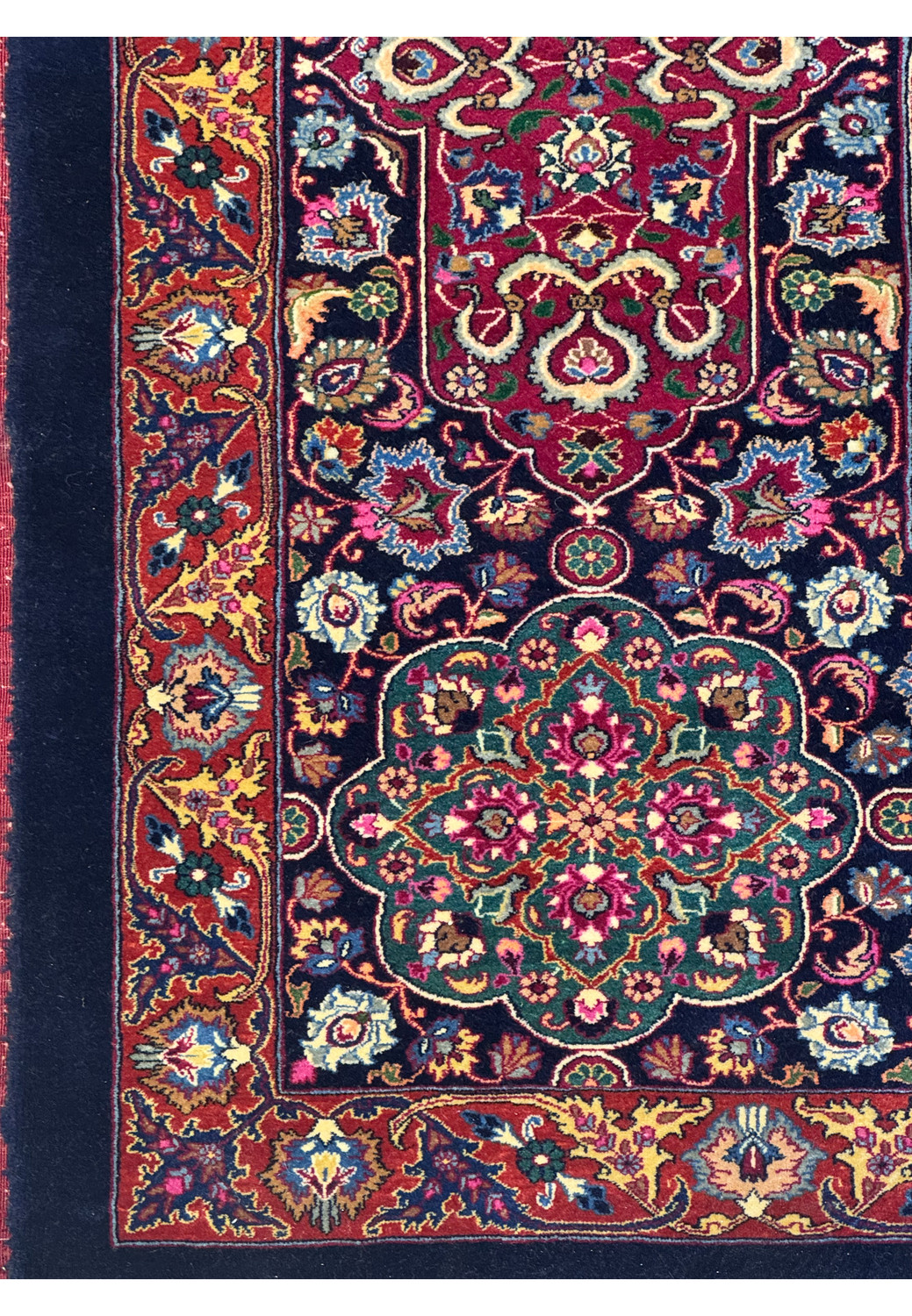 Close-up of floral motifs and scrolling patterns on a Persian Mashad rug, showcasing refined kork wool texture and balanced silk accents.