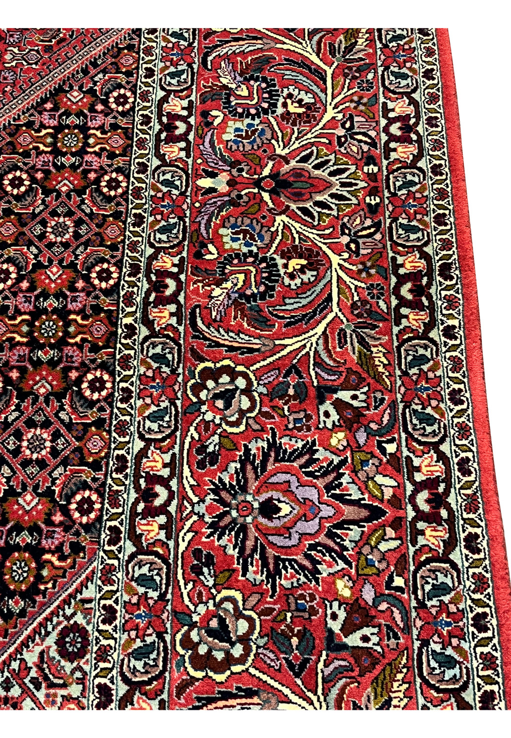 Border closeup of a Persian Bijar iron rug highlighting layered floral borders, deep red ground, navy accents, ivory details, and heavy wool construction