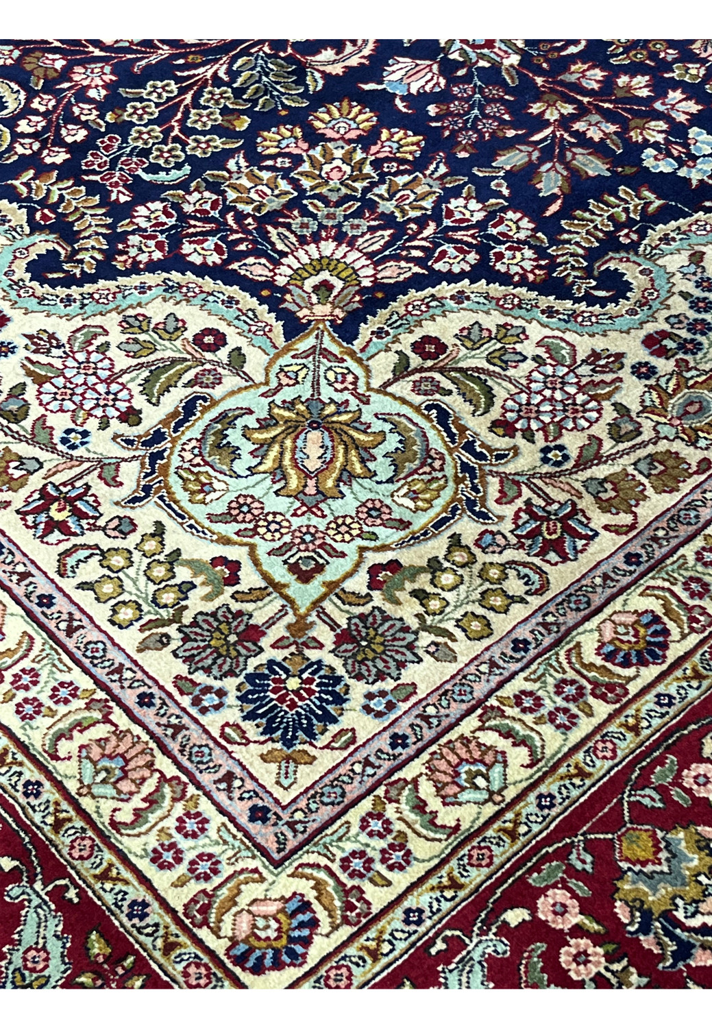 Inner border detail of an 11'2 x 14'4 Persian Tabriz rug with ivory ground, floral scrollwork, and refined navy outlines