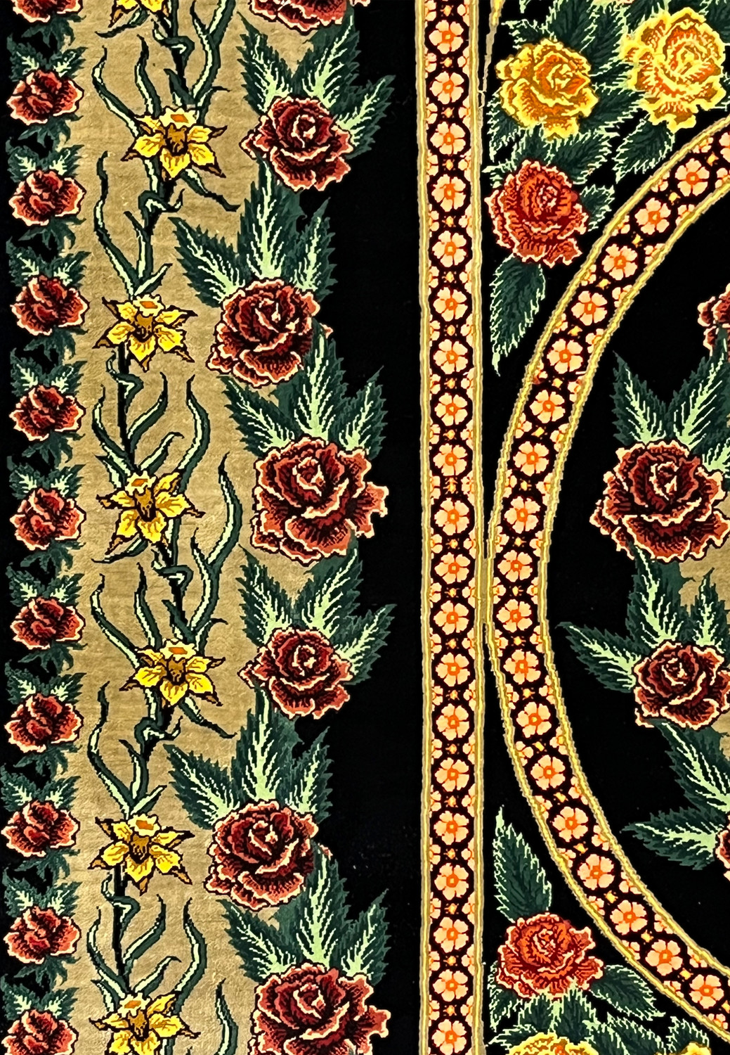 Side border detail of a signed Persian Qum silk rug showing continuous rose patterns, elegant vine movement, and clean transitions between field and border
