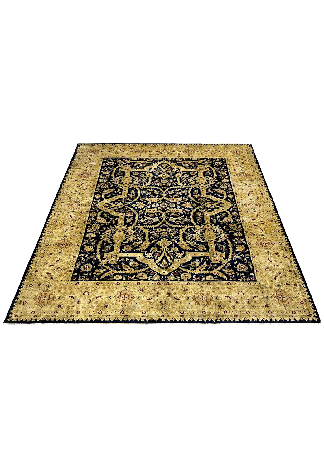 8' x 10' Indian Agra rug laid flat showing overall proportions, navy blue field, aged gold border, floral motifs, and even distress from long-term use