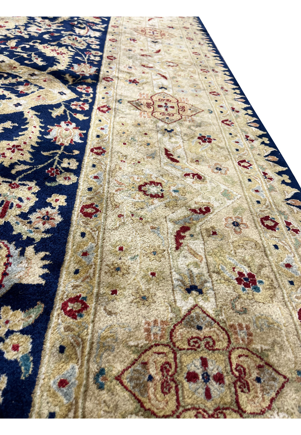 Border close-up highlighting the craftsmanship of a used Agra rug with floral medallions, antique gold tones, light abrasion, and repaired edges