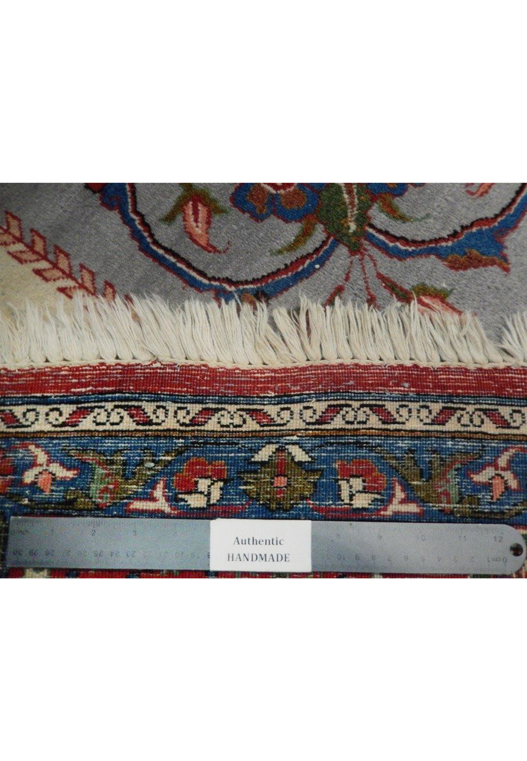 Fringe and lower border detail of a hand-knotted Persian Isfahan rug showing backside, tight knot structure, and clean edge finish
