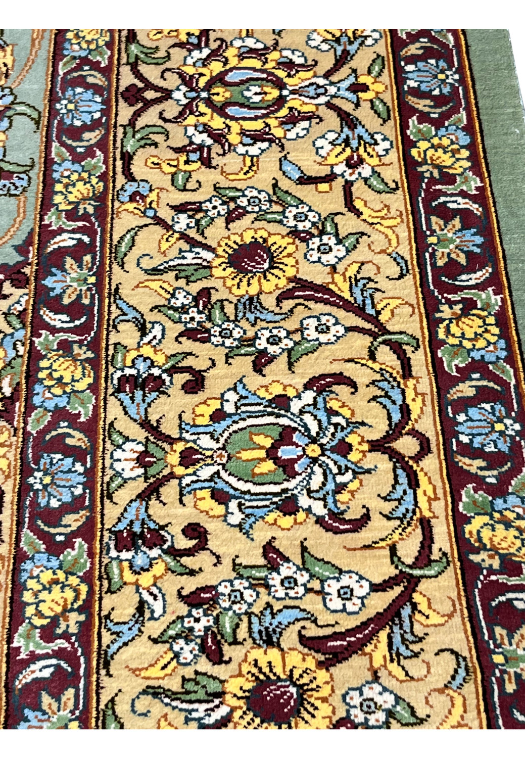 Extreme close-up of the border on a Persian Qum pure silk rug showing tight knot structure, sharp outlines, and luminous silk fibers