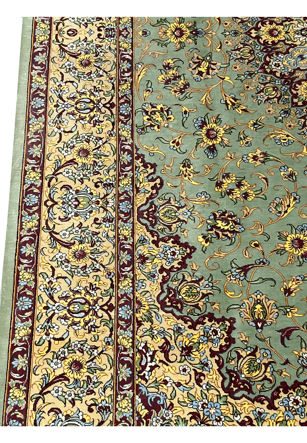 Side border detail of a Persian Qum pure silk rug showing precise floral scrollwork, ivory outlines, gold accents, and sharp Mirmehdi weaving