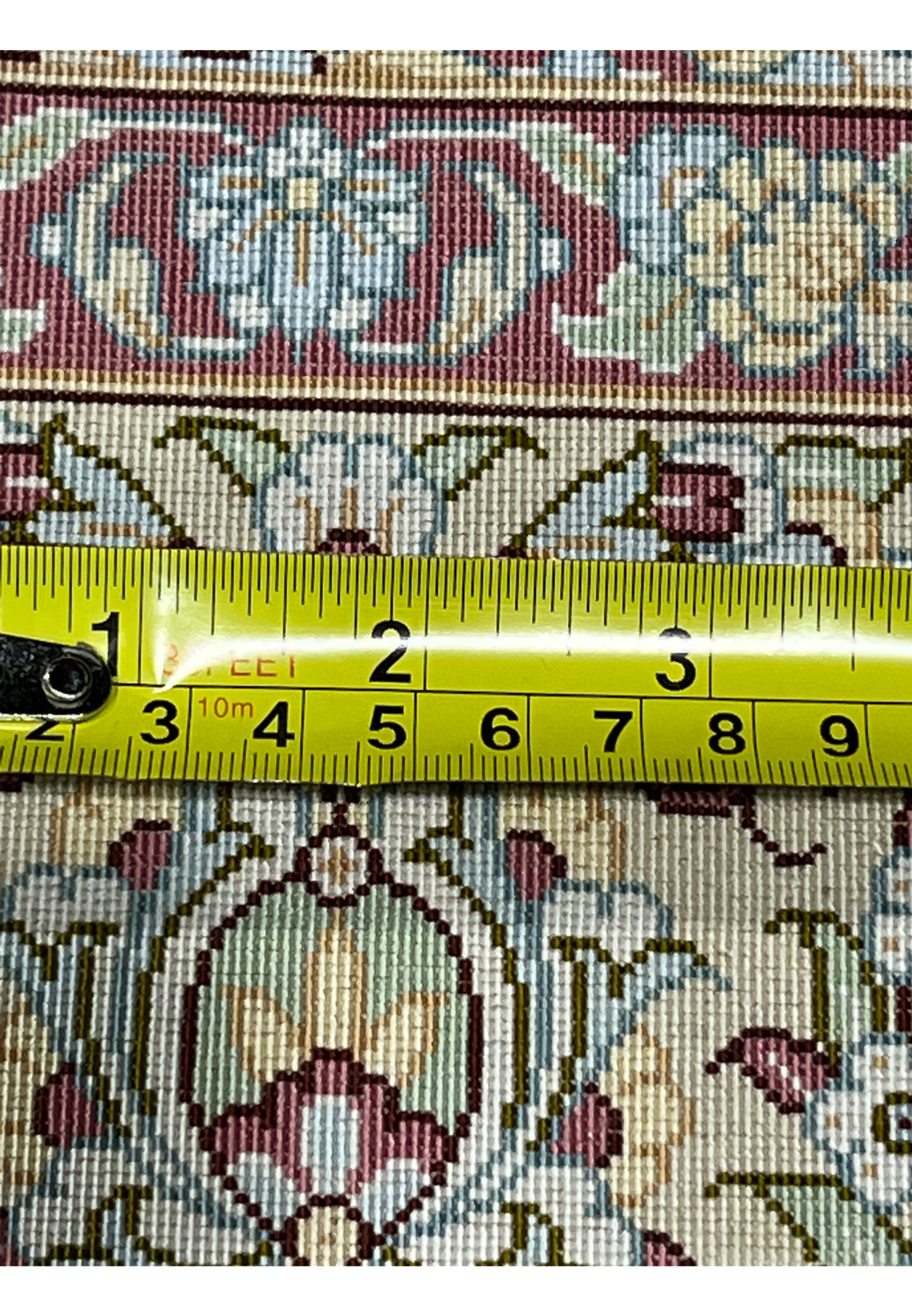 Backside detail of Persian Qum pure silk rug with ruler showing very high knot density and refined hand-knotting quality