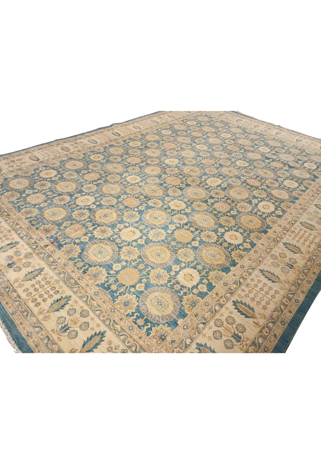 Angled perspective of an oversized light blue Oriental Chobi Peshawar rug highlighting depth, wool texture, repeating floral medallions, and tonal color variation