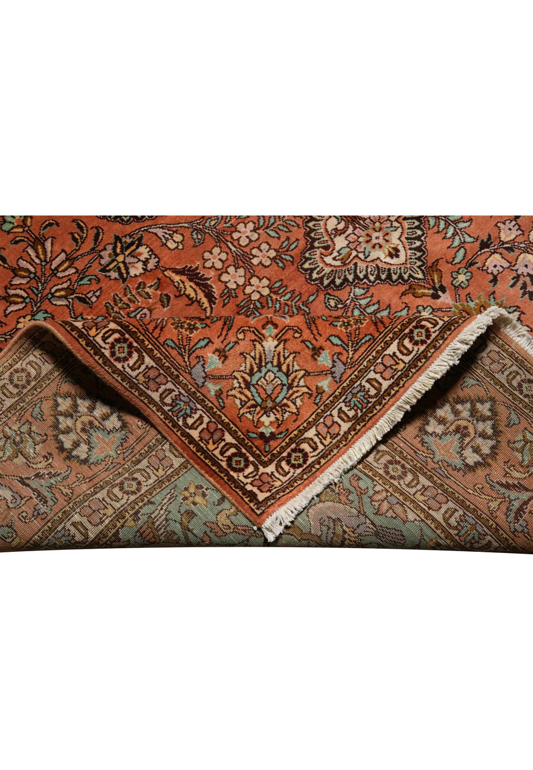 Folded edge detail of an 8'2 x 11'2 signed Paradies Persian Tabriz rug showing terracotta field, floral border, fine kork wool pile, and clean finishing