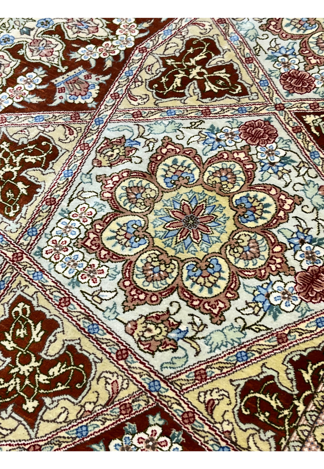 Silk close-up of signed Amjadi Persian Qum rug revealing luminous silk pile, fine knot density, and crisp woven floral detailing