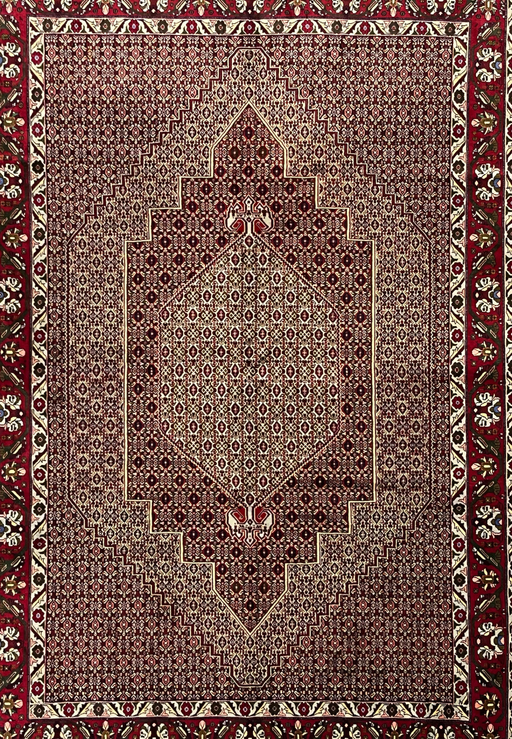Midfield detail of Persian Senneh rug showing tightly packed geometric lattice, ivory outlines, dark brown accents, and rhythmic repeating motifs