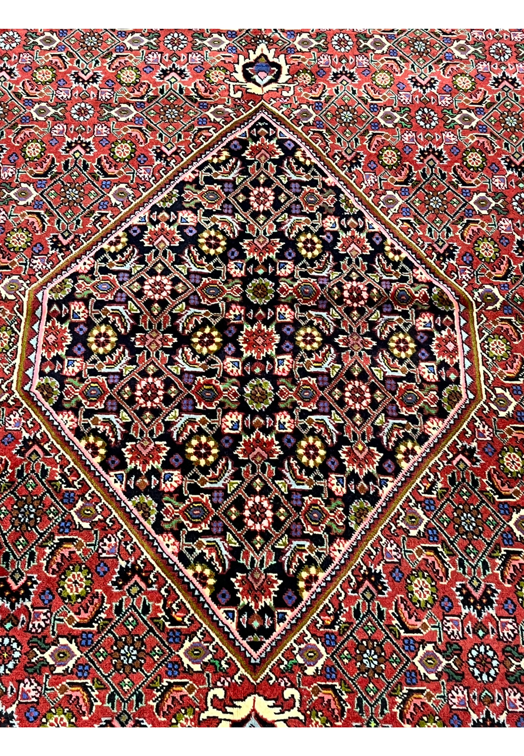 Central medallion close-up of Persian Bijar rug showcasing intricate geometric patterning, dark ground, and refined color detailing
