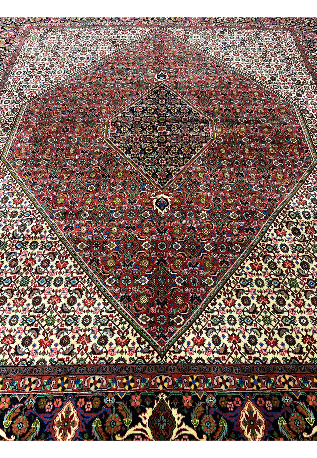 Laid down view of Persian Bijar rug illustrating overall proportions, strong medallion presence, ivory background, and balanced composition