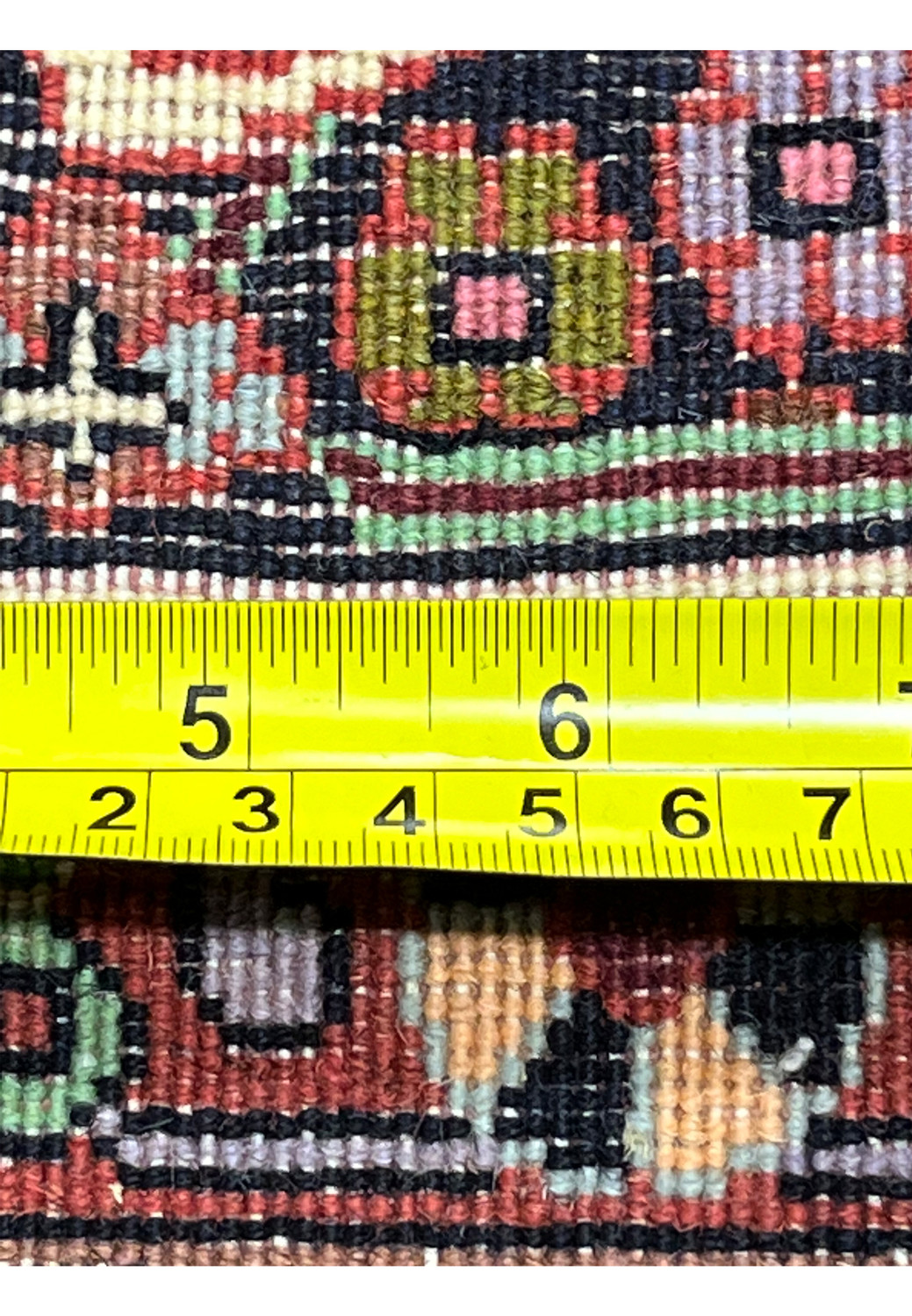 Backside close-up of Persian Bijar rug with ruler showing fine knot density, precise hand weaving, and compact construction typical of Bijar rugs.