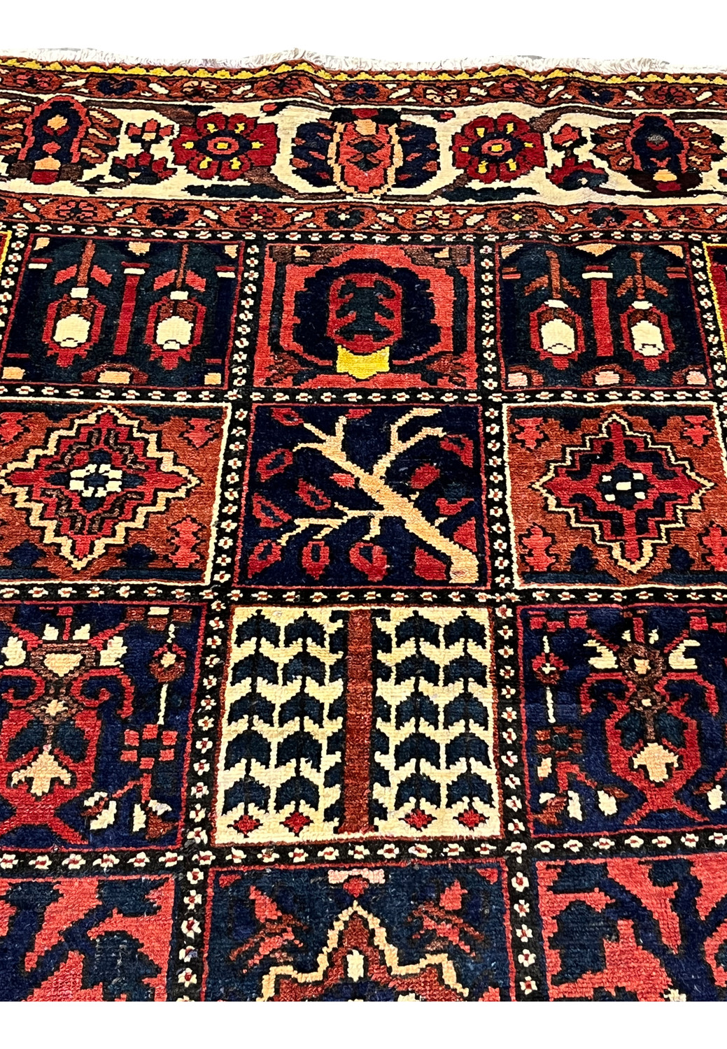 Pictorial square boxes in a Persian Bakhtiar rug showing trees, floral symbols, and geometric forms