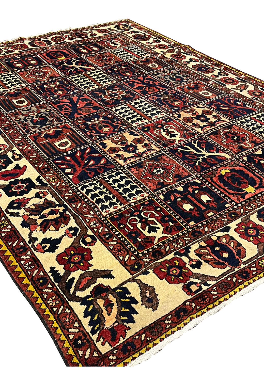 Angled perspective of a Persian Bakhtiar garden rug showing depth, texture, and pictorial panel design