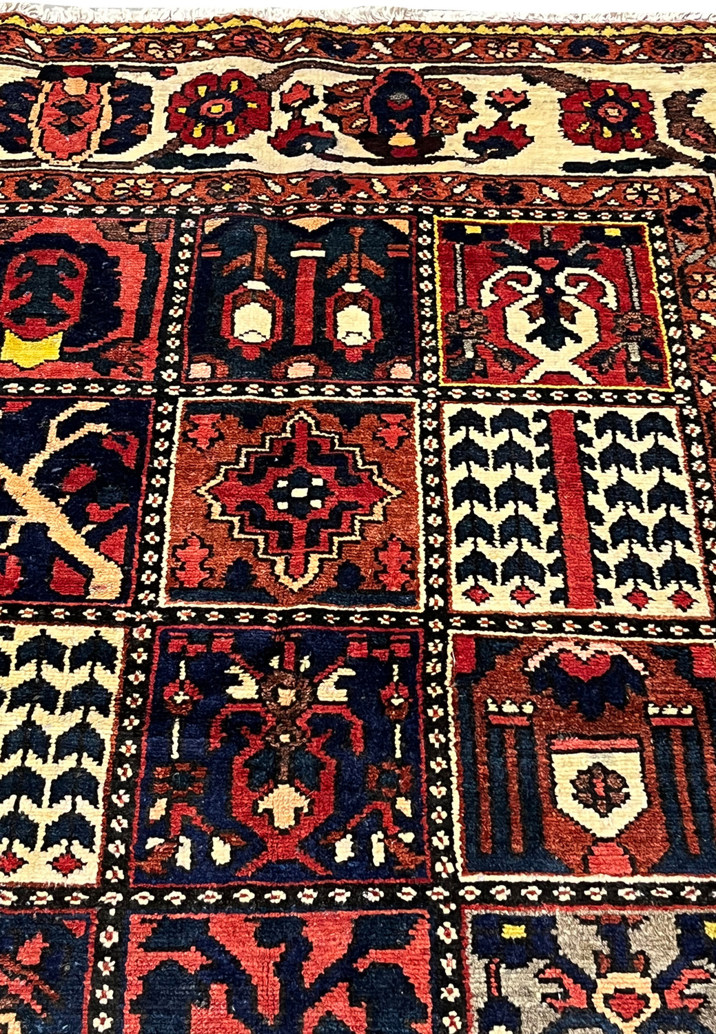 Pictorial square boxes in a Persian Bakhtiar rug showing trees, floral symbols, and geometric forms