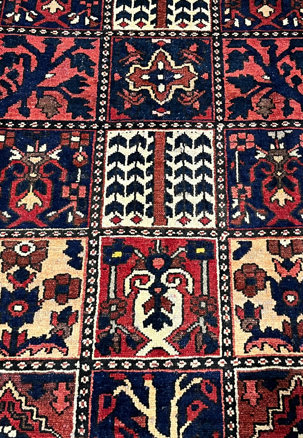 Panel design detail of a Persian Bakhtiar rug featuring symbolic garden and tribal motifs