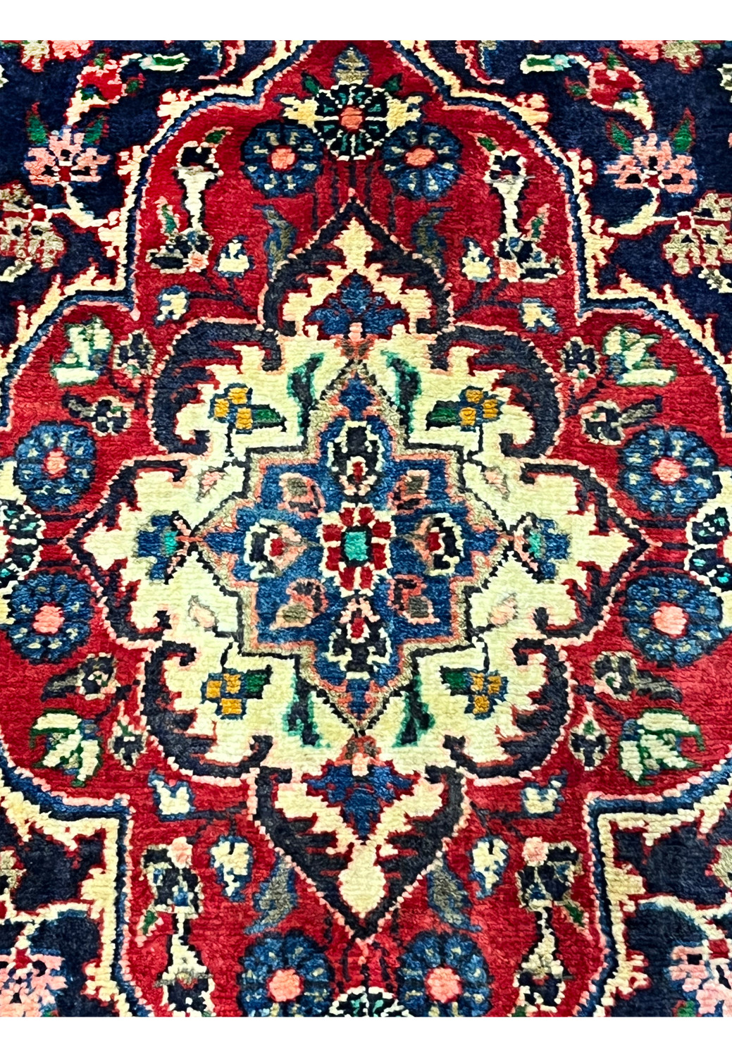 Zoomed medallion detail Persian Mahal rug with dense floral motifs ivory accents and crisp hand knotted outlines