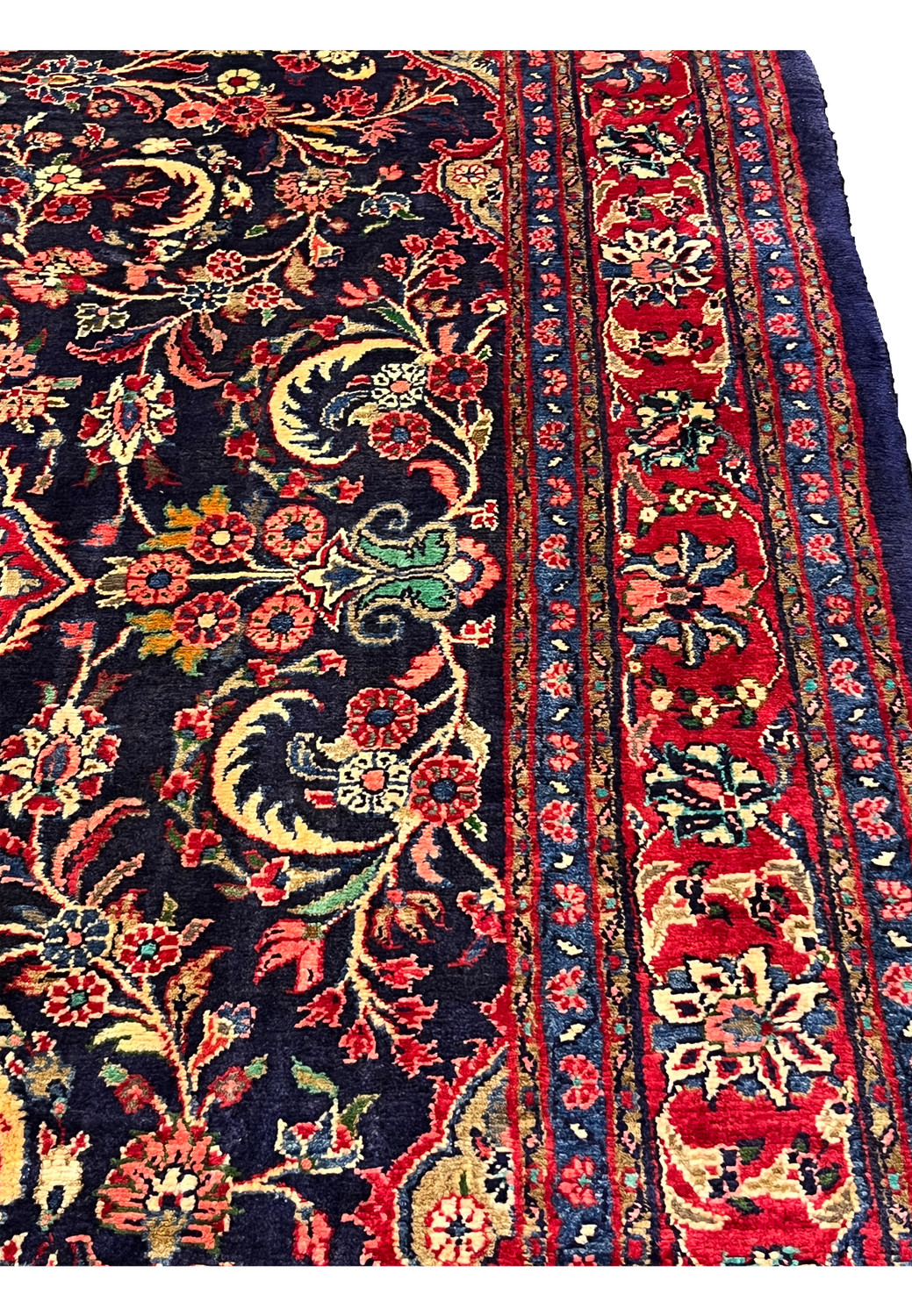 Angled perspective Persian Mahal rug highlighting pile height wool texture and rich navy and red color contrast