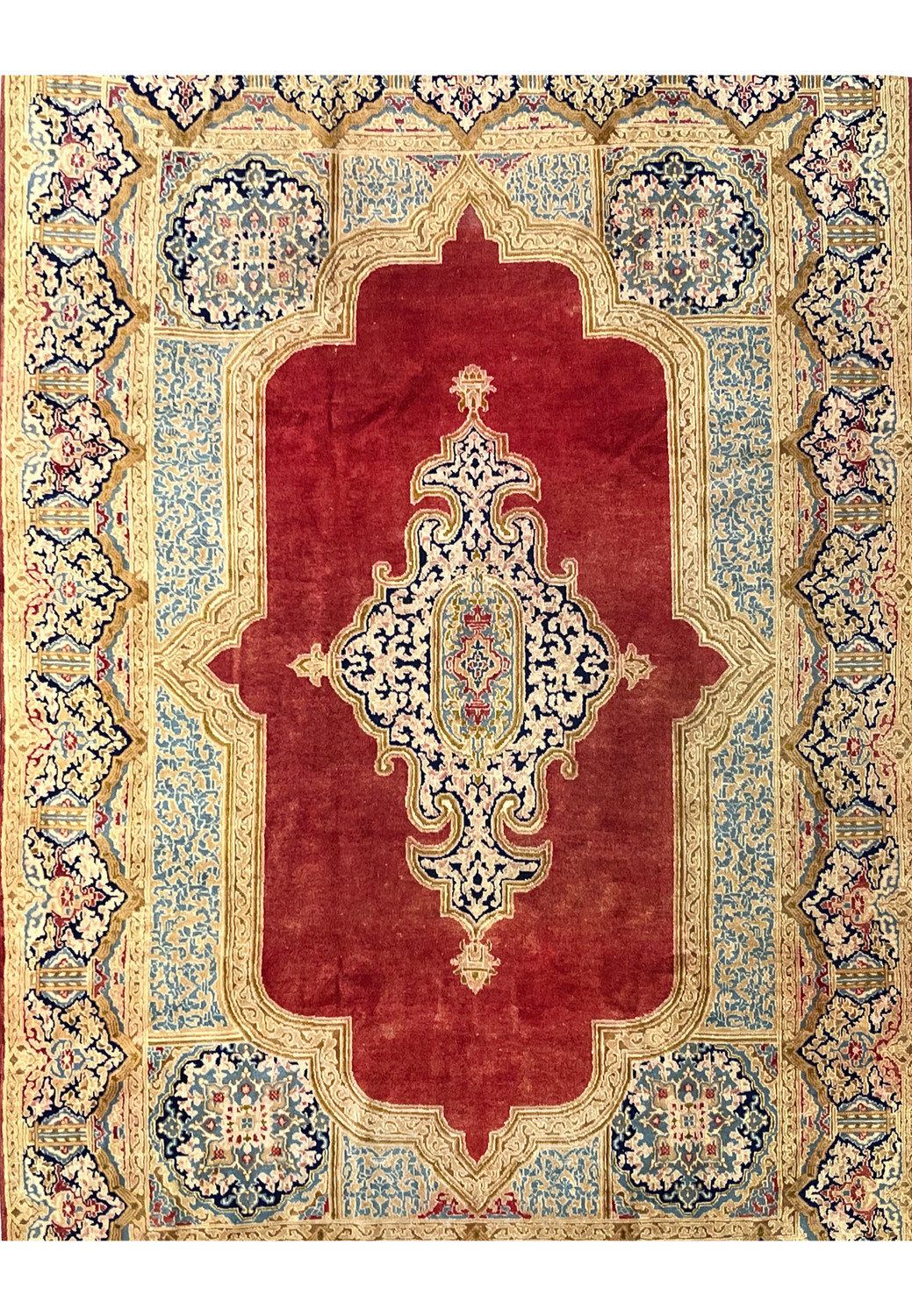 Antique Persian Kerman rug midfield close view brick red field ivory floral medallion navy vines hand knotted wool distressed patina