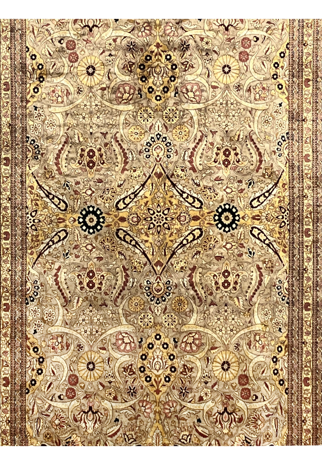 Midfield close view of Agra rug showing scrolling vines, rosettes, gold accents, and intricate beige tan floral detailing
