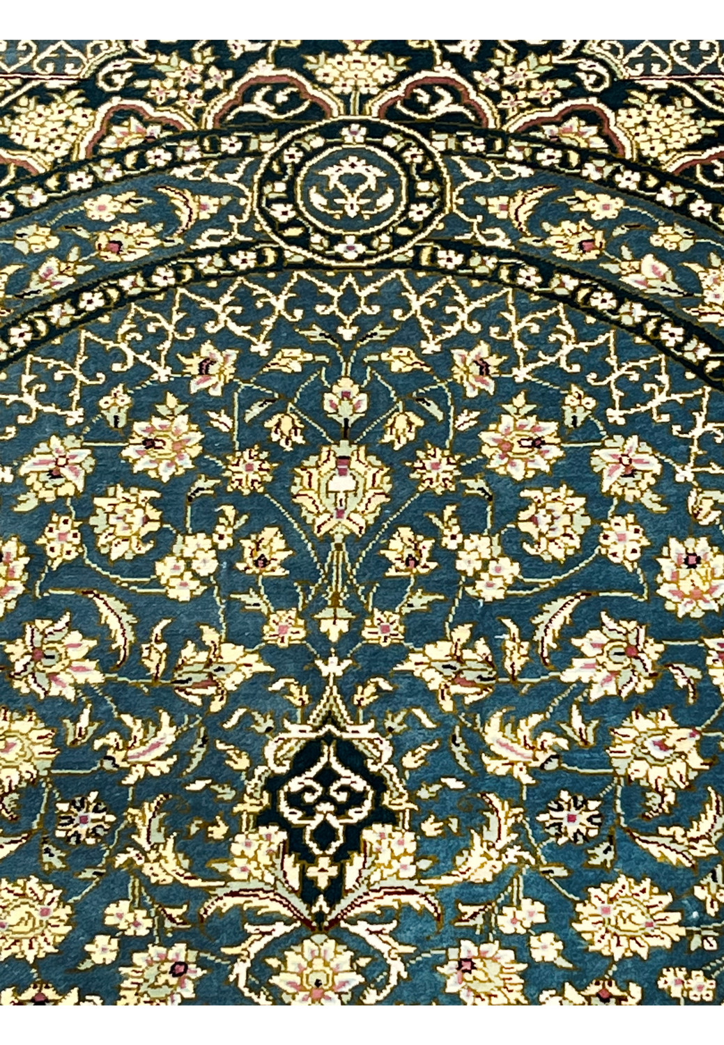 Macro color closeup of silk pile revealing teal blue, ivory, gold and blush tones with ultra fine knots and smooth velvet like texture