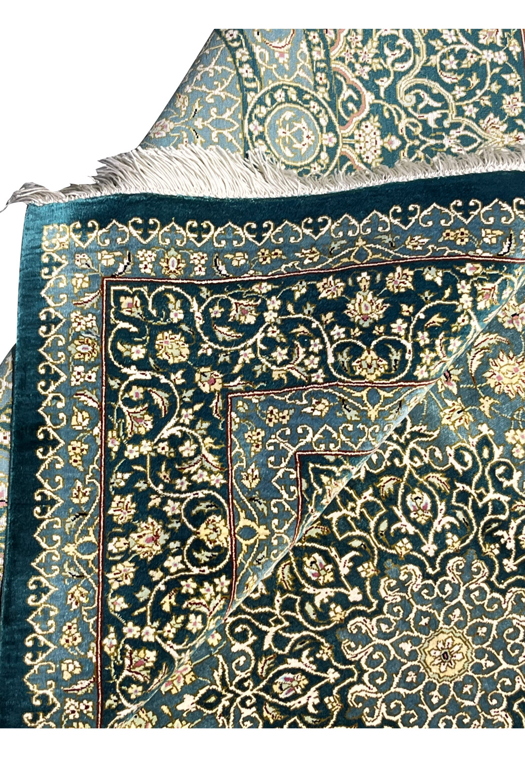 Folded edge detail of silk handmade rug showing clean backing, tight knots and crisp floral pattern alignment along border