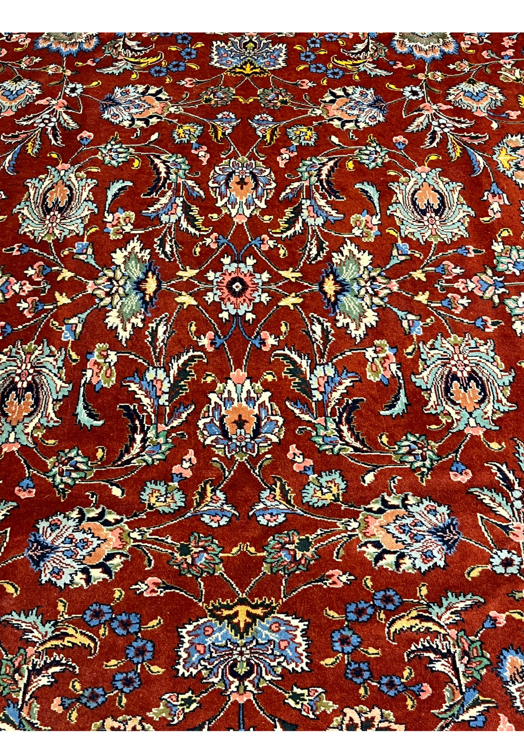 Detailed botanical motifs red field light blue sage green flowers and fine vines hand knotted Persian craftsmanship