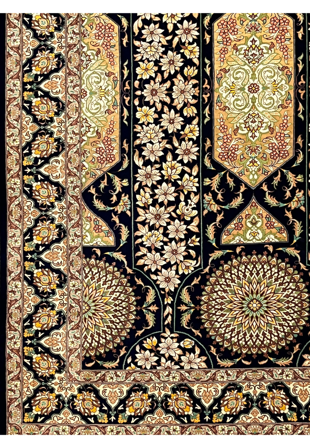 Botanical vine motifs and blossoms in ivory blush and sage on navy silk field showing fine knot detail collectible Persian Qum silk rug