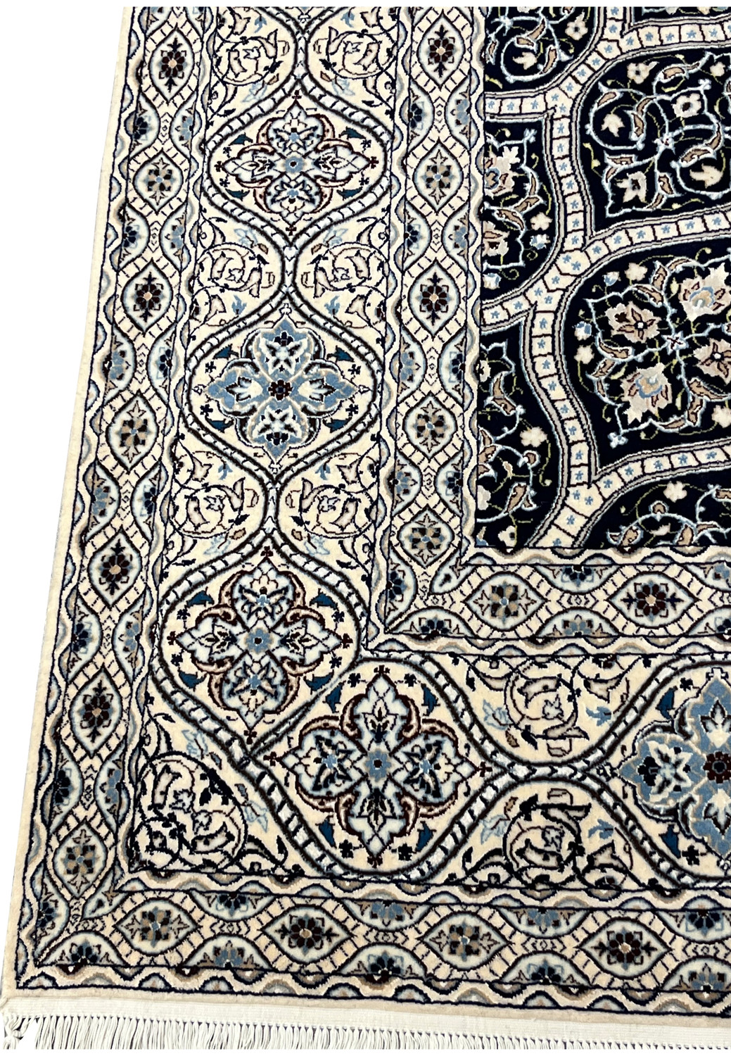 Side view showing low dense pile of Persian Nain 6 LA Kork wool rug with silk floral highlights navy dome pattern.