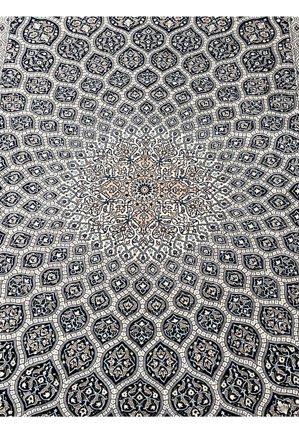 Close view of Nain 6 LA Gombadi dome medallion with silk floral details ivory and navy field fine Habibian craftsmanship.