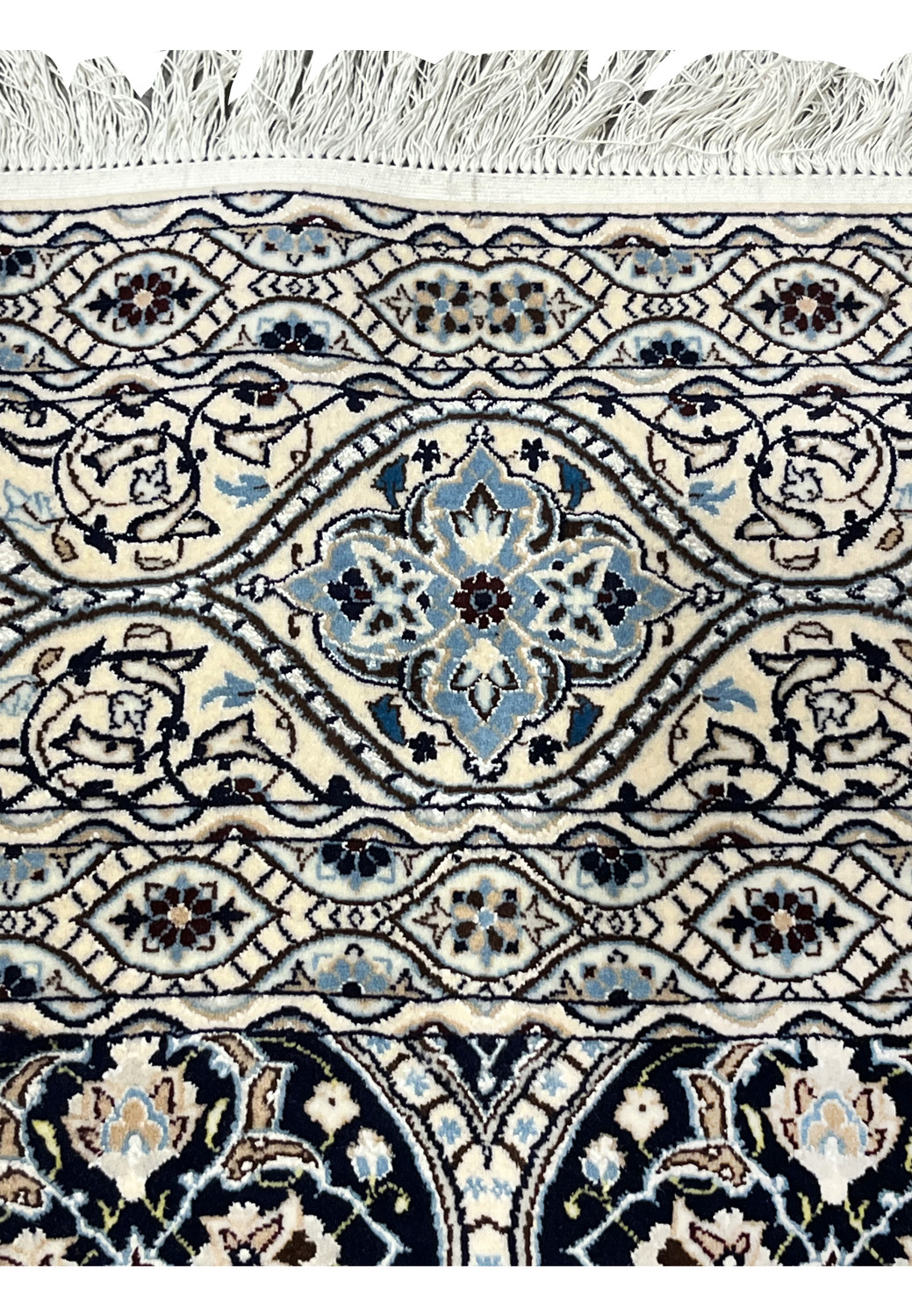 Upper border of Persian Nain Habibian 6 LA rug with scrolling vines light blue palmettes and navy outlines.