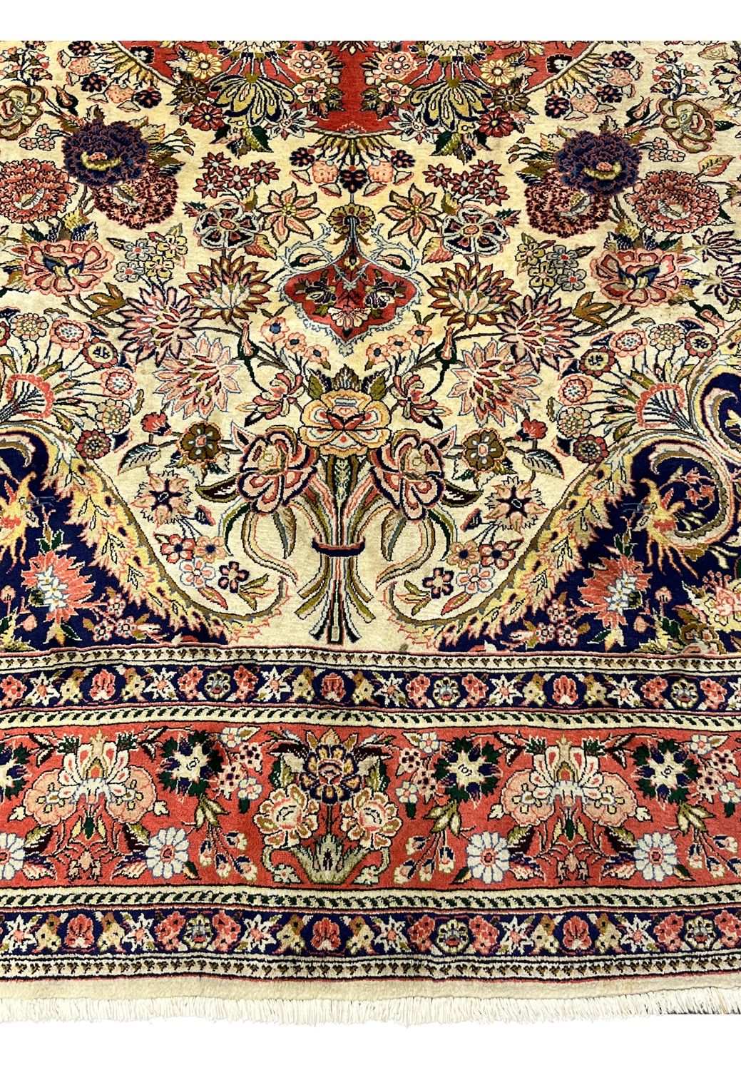 Lower border of Persian Bijar rug featuring coral red main border navy guard stripes and floral vine motifs